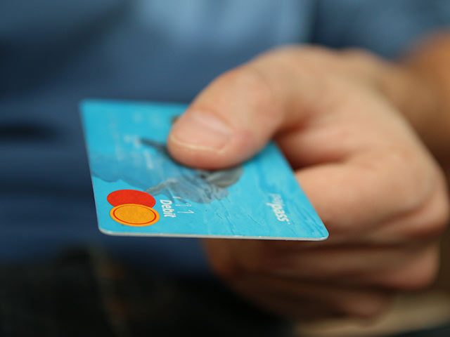 Close up of hand holding a credit card