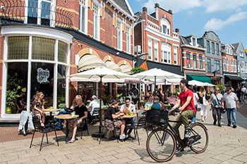 Enschede buildings with people socialising and bicycles