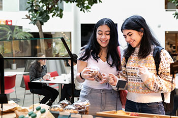 Female students choosing food at campus café