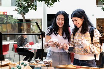 Female students choosing food at campus café