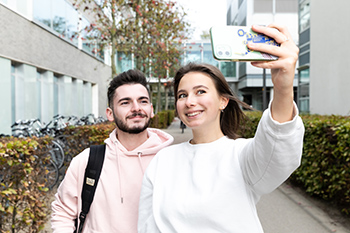 Two students taking a selfie on mobile phone.